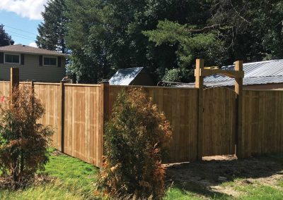 Residential backyard with a wooden fence and gate