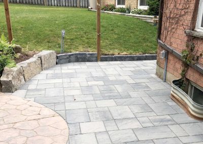 Interlocking stone patio in residential backyard