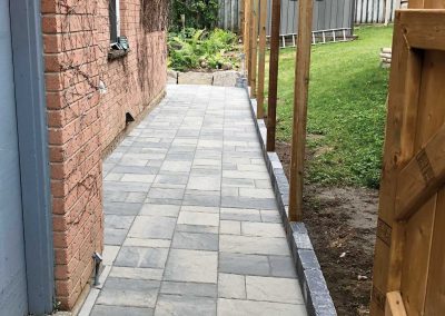 Interlocking stone residential backyard pathway