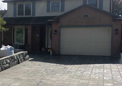 Front of residential house interlocking stone driveway