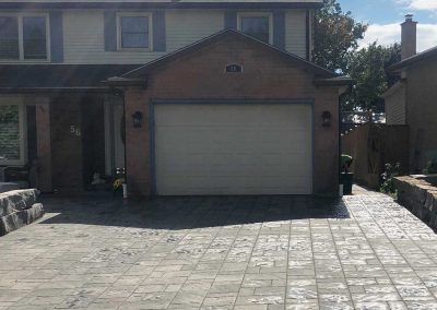 Interlocking stone driveway located in the front of a residential house